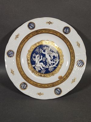 an image of a blue and white plate with a gold border