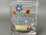 a glass with a flower pot on it on a table