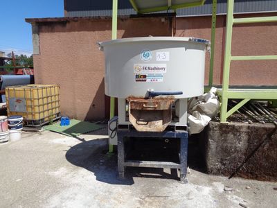 an image of a large white tank sitting on top of a cement slab
