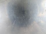 a close up of a metal object on a white surface