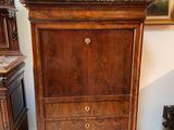 a wooden cabinet with a marble top in a room
