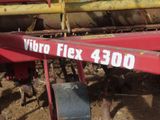 a close up of a red tractor with a sign that says vibro flex 3400