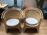 two wicker chairs in the corner of the room