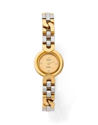 a close up of a gold and silver watch on a white background