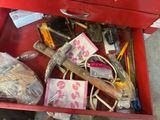 a red tool box filled with assorted items