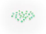 a group of green tourmaline gems on a white surface