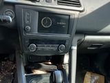 a dashboard of a car with a clock and a steering wheel