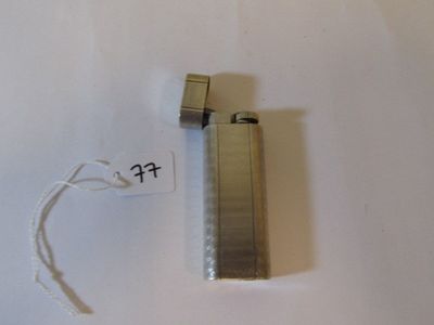 a lighter that is sitting on a white surface