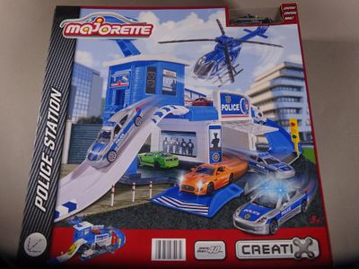 toys are in a box on a table in front of a white wall