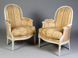 a pair of chairs with striped upholstered upholstered cushions