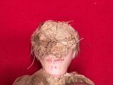 a person holding a teddy bear on a red surface