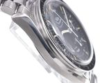 a close up of a watch on a white surface