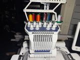 a machine that is sitting on a table with a computer