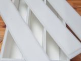 four white trays on a wooden table on the floor