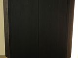 the cabinet is made of wood and has metal legs