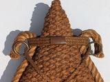 rope wrapped around a starfish hanging on a wall in the snow