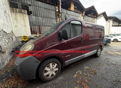 an image of a maroon van parked in front of a building
