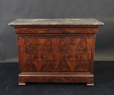 an antique chest of drawers with marble top