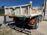 a dump truck that is parked on the side of the road