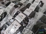 a pile of black and white shirts wrapped in plastic