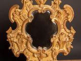 un miroir doré posé sur une table en bois