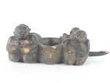 a small statue of two elephants sitting on top of each other