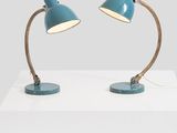 a pair of blue desk lamps on a white table