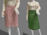 two mannequins dressed in pink and green are standing next to each other