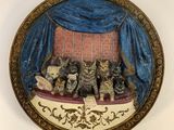 a picture of a picture of a group of cats sitting on a couch