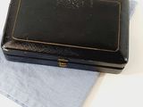 a small black box sitting on top of a blue cloth
