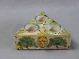 a small box with a candle holder on it