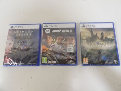 three video games are sitting on a table with a white table cloth