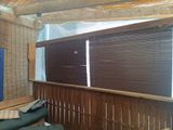 a couch that is in a room with wooden blinds