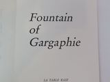 a white book with black writing on it sitting on a table