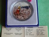 a silver coin in a blue box on a green surface