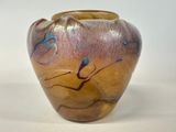a brown vase with blue and purple designs on it