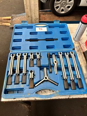 une boîte à outils bleue contenant des outils, posée sur une table