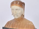 a statue of a man with a hat on a shelf