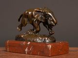 a bronze statue of an elephant on a marble base