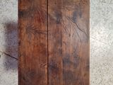 two pieces of wood sitting on a tile floor