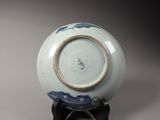 a small blue and white bowl on a stand