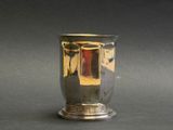 a silver vase that is sitting on a table