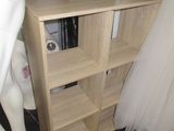 two mannequins and a shelf in a room
