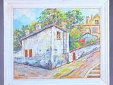 a painting on a easel with a picture of a house