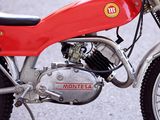 a red motorcycle parked on the side of the road