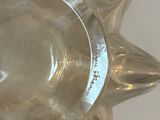 a clear glass vase with a star on top of it