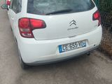 a white car that is parked on the side of the road