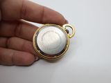 an image of a person holding a gold watch in their hand