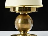 an image of a gold lamp with a white shade on top of it
