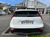 a white car parked in a parking lot next to a building